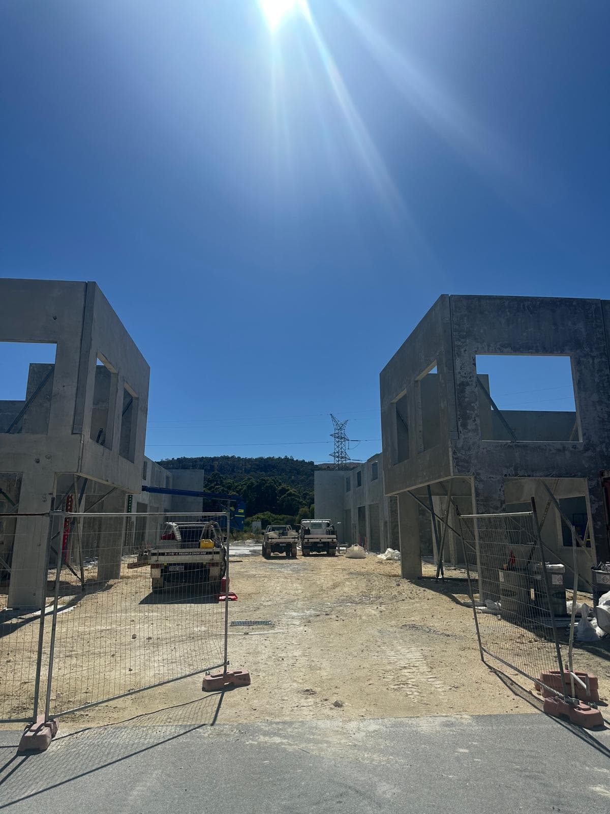 Two rows of precast commercial building shells — street-level view