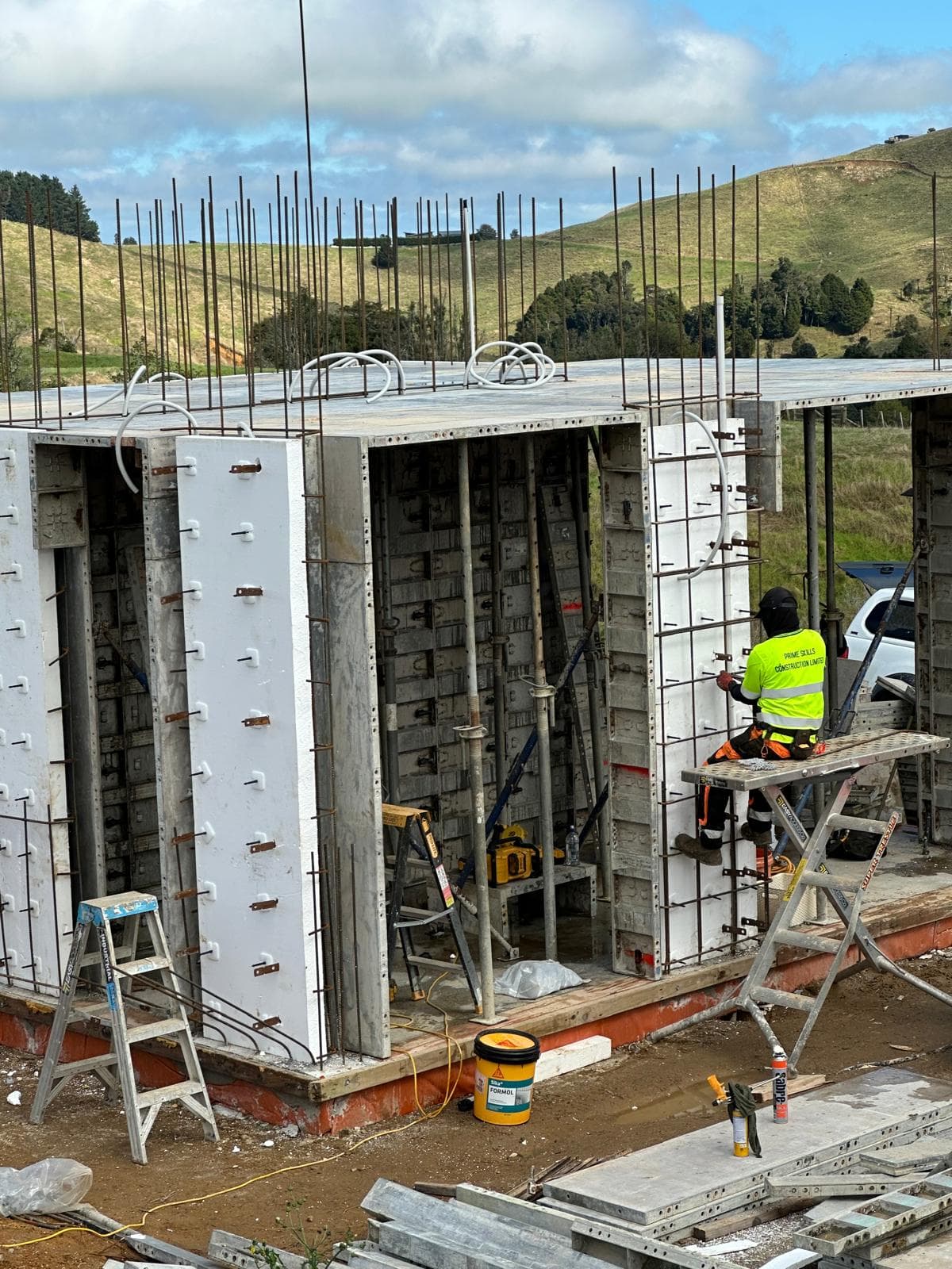Worker assembling ThermaCast formwork panels on site