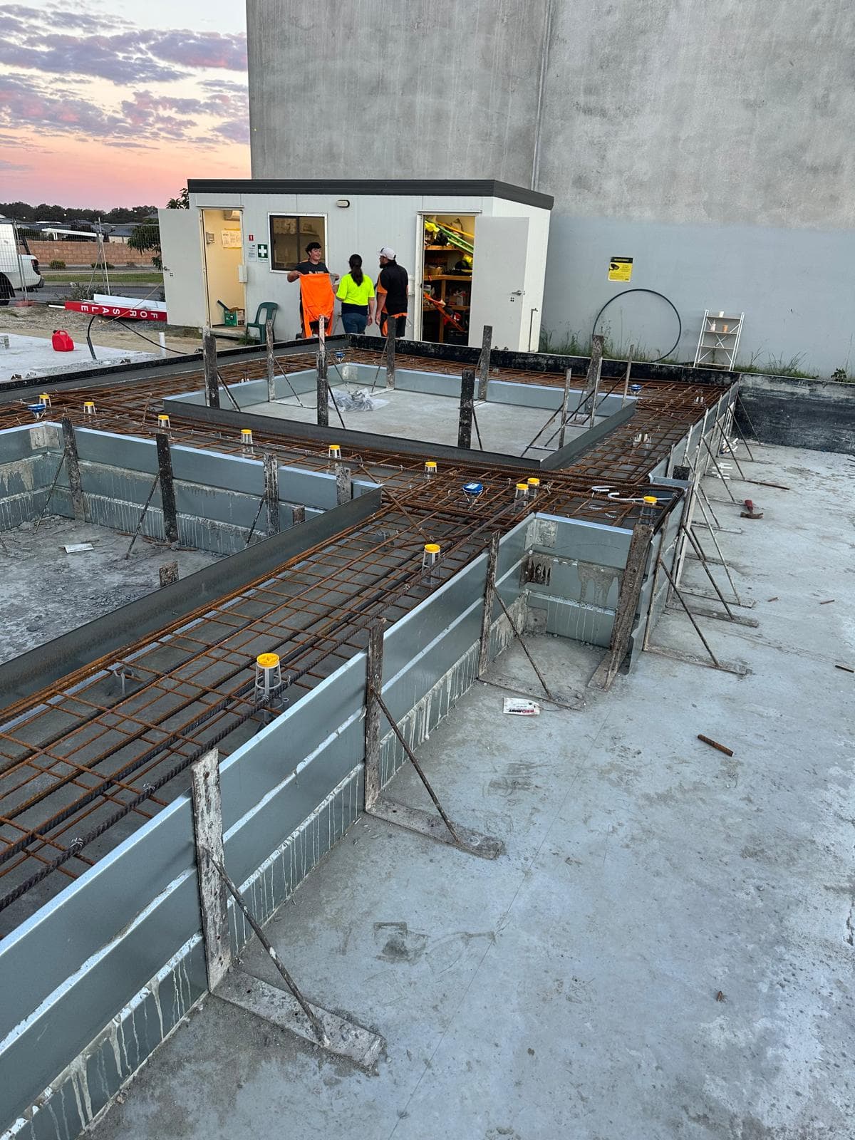 Precast panel forms with rebar at dusk